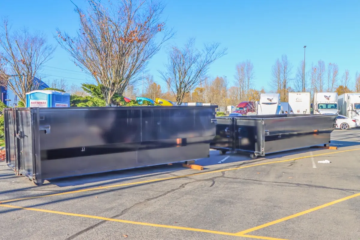 Professional dumpster rental service with roll-off container on residential driveway in Willingboro